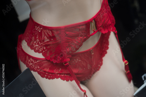 closeup of red suspended belt on mannequin in a fashion store showroom