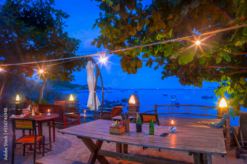Bai Xep is a quiet remote fishing village off the tourist path, 10km from the major city of Qui Nhon. A table is set up for a beautiful sunset dinner at night; Bai Xep, Qui Nhon, Vietnam photo