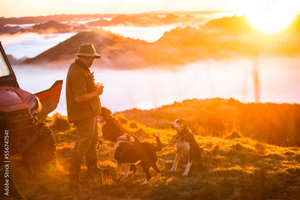 Man drinking coffee at sunrise, Blue Duck Station, Whanganui National