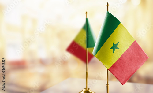 Small flags of the Senegal on an abstract blurry background