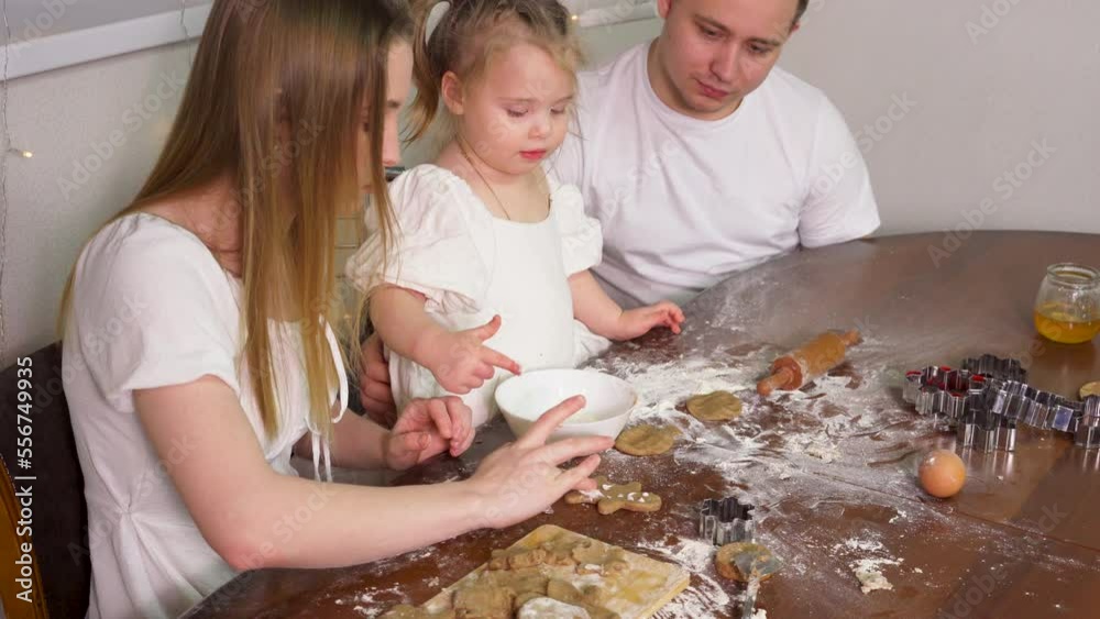 Happy family having fun with flour while cooking cookies. Happy family having fun with flour while cooking cookies.
