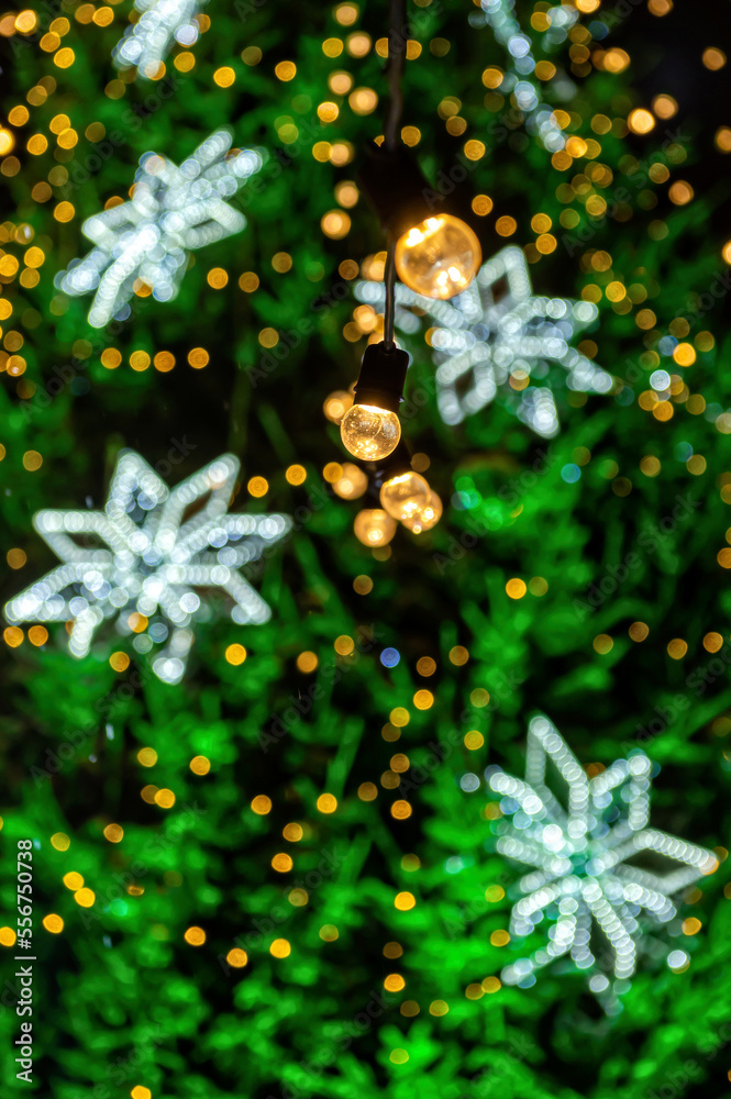 garland of light bulbs on defocused festive lights background, shallow depth of field, copy space garland of light bulbs on defocused festive lights background, shallow depth of field, copy space
