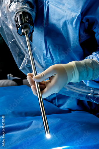 Doctor holding robotic surgical equipment photo