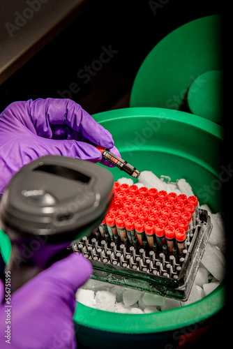 Medical lab technician holding vials in a hospital lab photo