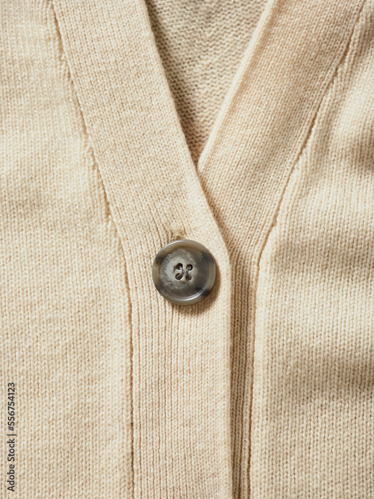 Close-up detail of Cardigan sweater with button; Studio Close-up detail of Cardigan sweater with button; Studio