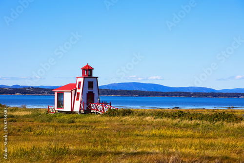 Small red and white lighthouse along the Saint Lawrence River; Saint Andre de Kamourraska, Quebec, Canada photo