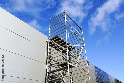 Quadro em tela Modern metal tubular multilevel scaffolding next to the sandwich panel facade