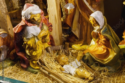 Stampa su tela Statuettes of Mary, Joseph and the newborn baby Jesus in the hay, A Christmas crib