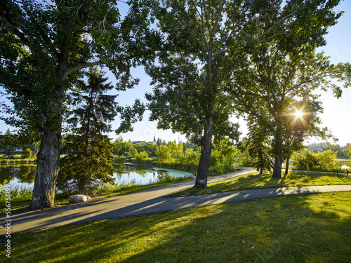 Sunlight and shadows fall on the trails in Mirror Lake Park at sunrise; Camrose, Alberta, Canada photo