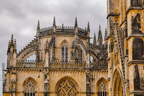 Close-up of the Gothic stonework and rooftop detail with a grey sky at the Batalha Monastery; Batalha, District of Leiria, Centro Region, Portugal photo
