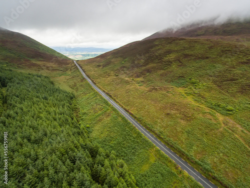 Aerial View of the scenic drive along the road known as The Vee with its forested green mountains; County Waterford, Ireland photo