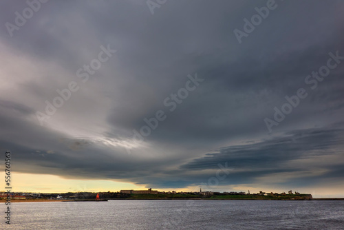 Herd Groyne Lighthouse under threatening storm clouds; South Shields, Tyne and Wear, England photo