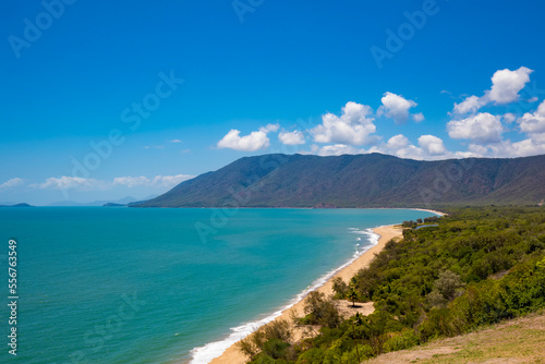 Scenic view overlooking the sandy beach, mountains and vegetation where the Daintree Rainforest meets the Coral Sea on the Pacific Ocean Coast in Eastern Kuku Yalanji; Daintree, Queensland, Australia photo