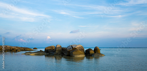 Dawn over a lagoon with rock formations along the shore of the calm, waters on the coast of Ko Samui Island in the Gulf of Thailand; Ko Samui, Surat Thani, Thailand photo