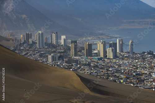 South part of the port city of Iquique with skyline and Cerro Dragon (Dragon Hill) the large, urban sand dune that overlooks the city; Iquique, Tarapaca, Chile photo