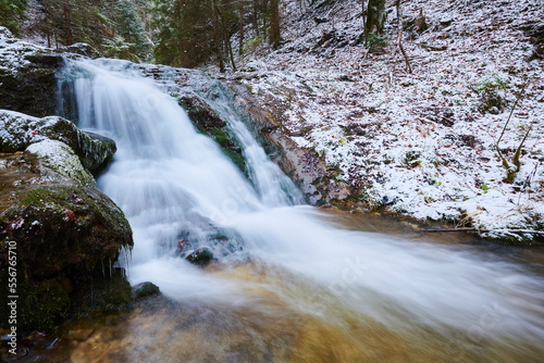 Snowy waterfall with rushing cascade at Janosikove Diery in winter; Little Fatra (Kleine Fatra), Carpathian Mountains, Terchova, Slovakia photo