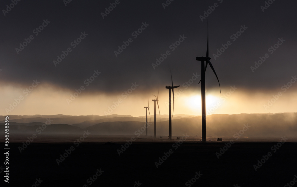 Obraz premium Wind generation towers in the sunlight during sunrise
