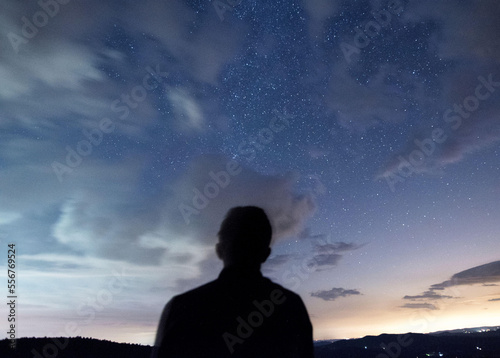 Silhouette of a man looking up at a star filled sky along Skyline Drive in Shenandoah National Park in Virginia.