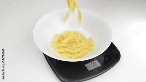 Weighing 100 grams of pasta on a digital scale