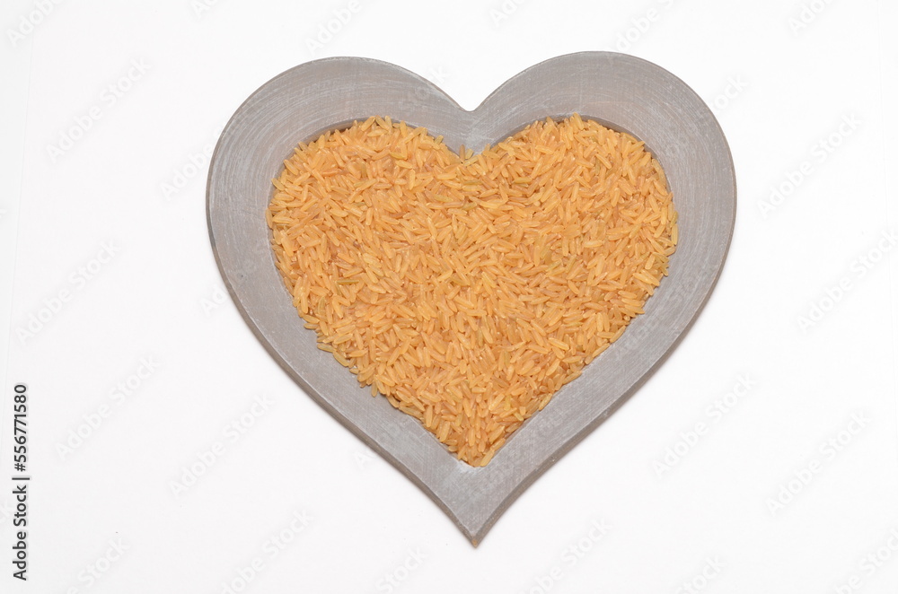 chinese bronze rice in a heart shaped frame on white background