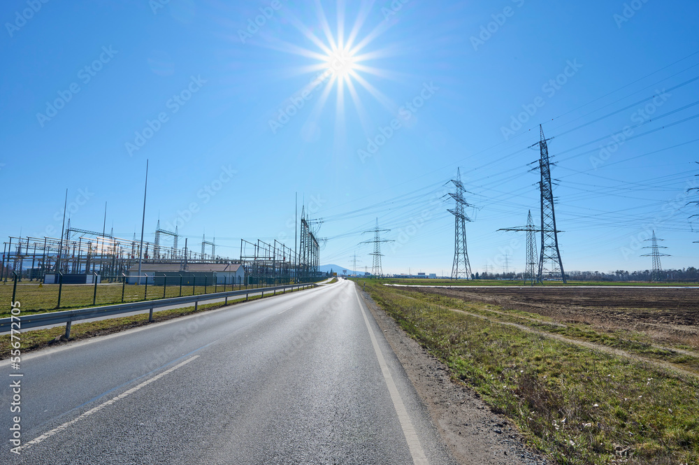 Road with electricity pylons and electricity substation in countryside; Hesse, Germany Road with electricity pylons and electricity substation in countryside; Hesse, Germany