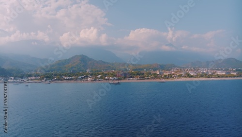 Panorama view of the blue sea. Beautiful clouds. Mountains in the background. Seascape. Photography