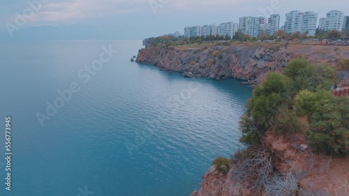 Fototapeta Naklejka Na Ścianę i Meble -  The concept of nature and man. A look from above at the blue sea, rocks and residential buildings on the shore. Riviera