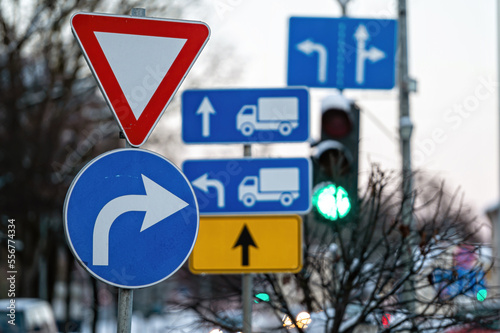 Cars moving on the road in city in winter. View to the traffic with signs, trafficlights and cars photo