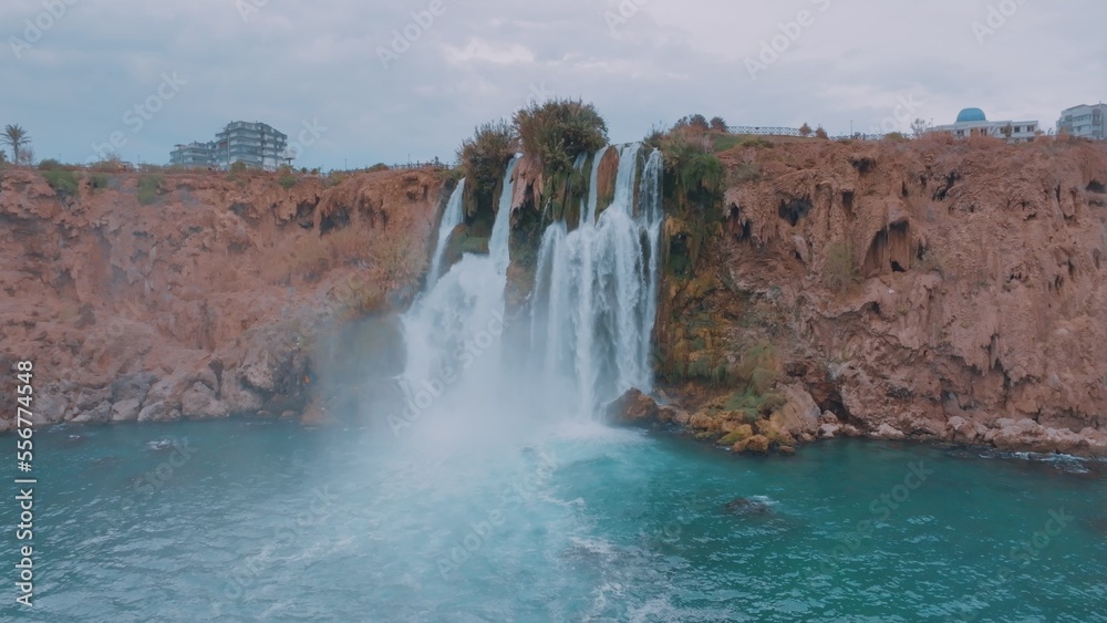 Beautiful stormy waterfall. Turquoise lagoon in a tourist place. Pure water. Aerial drone view Beautiful stormy waterfall. Turquoise lagoon in a tourist place. Pure water. Aerial drone view