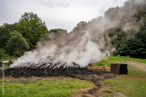 Charcoal makers burning mound; Transylvania, Romania photo