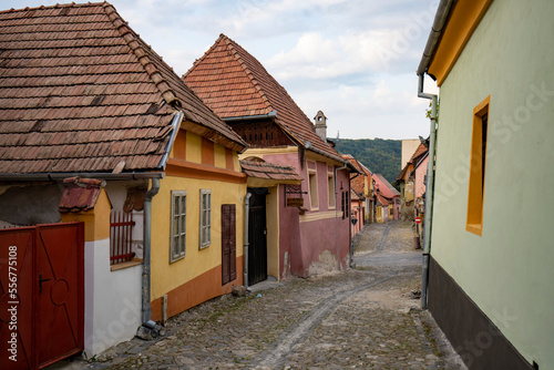 Cobblestone backstreets and colorful buildings inside the Citadel Old Town of Sighisoara, birth place of Vlad Tepes (Dracula); Sighisoara, Transylvania, Romania photo