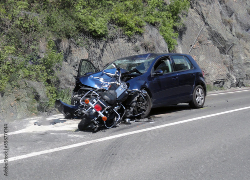Fatal frontal accident between a motorcyclist and a car. A motorcyclist loses his life after a dangerous overtaking on the road due to high speed.