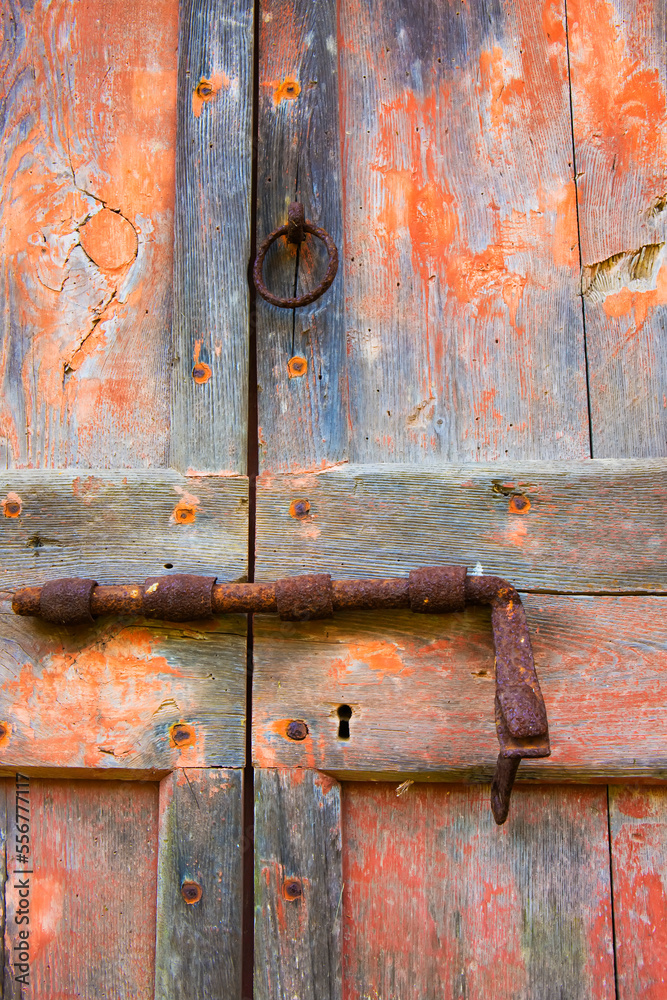 Old door latch, rusty and on weathered wooden doors; Tuscany, Italy Old door latch, rusty and on weathered wooden doors; Tuscany, Italy