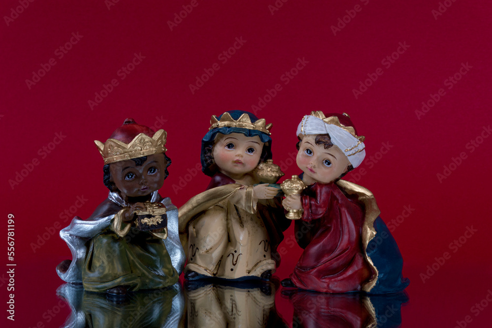 Happy Three King's Day. Three wise men on dark red background. Concept for Reyes Magos, Three Wise Men or Happy Epiphany day.