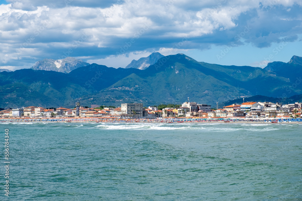 Low clouds and high mountains over beach town of Viareggio in Italy.