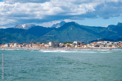 Low clouds and high mountains over beach town of Viareggio in Italy. photo