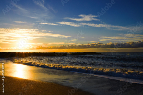 Beautiful sunset on the beach and sea with waves, Denmark