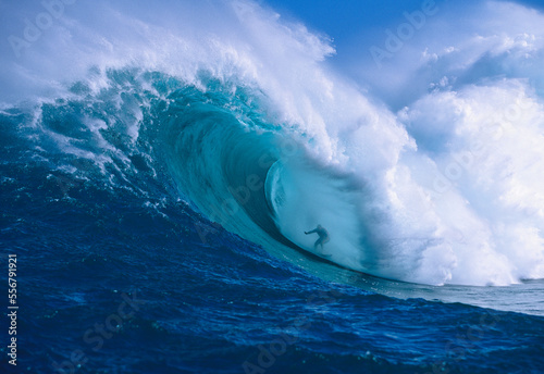 Professional surfer, Garrett McNamara, surfing in the barrel at Jaws (also known as Peahi) on the North Shore of Maui; Maui, Hawaii, United States of America photo