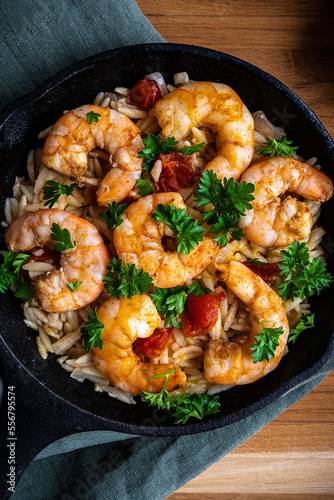 Shrimp scampi with pasta (orzo) garnished with parsley and grape tomatoes