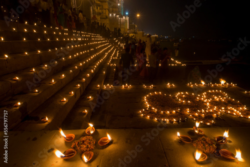 People gather at the ghats in Varanasi for Dev Deepawali with candles lit at night in celebration of the the festival of Kartik Poornima; Varanasi, India photo