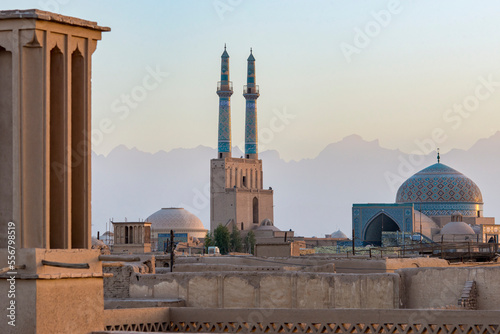 Overview of Jamesh Mosque of Yazd at sunset with the soft silhouette of the Zagros Mountain in the distance; Yazd City, Yazd Province, Iran photo
