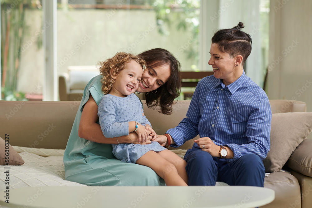 Lesbian couple enjoying spending time with their little daughter Lesbian couple enjoying spending time with their little daughter