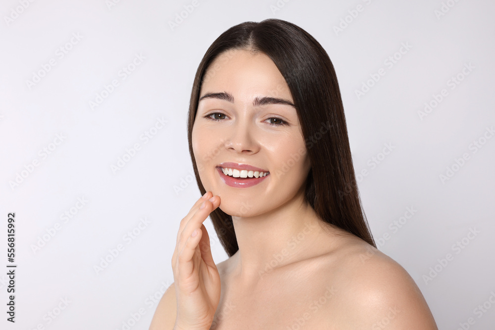 Portrait of attractive young woman on light grey background. Spa treatment Portrait of attractive young woman on light grey background. Spa treatment