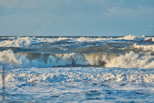 Fotografie huge breaking waves at north sea coast. High quality photo