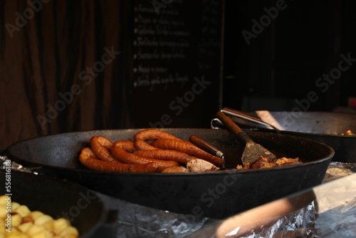 Delicious cooked sausages in frying pan indoors photo