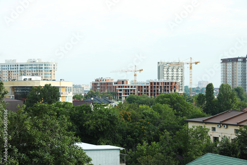 Multistoried residential buildings and construction cranes in city