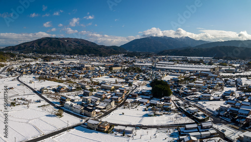 Aerial view of Sekigahara homes and fields in winter snow  photo