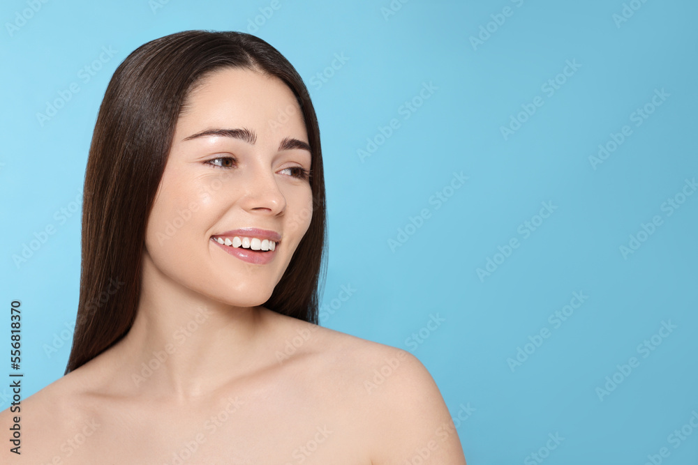 Portrait of attractive young woman on light blue background, space for text. Spa treatment Portrait of attractive young woman on light blue background, space for text. Spa treatment
