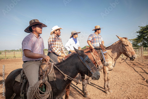 Men in traditional clothing on horseback in fields of San Marcos Guatemala.