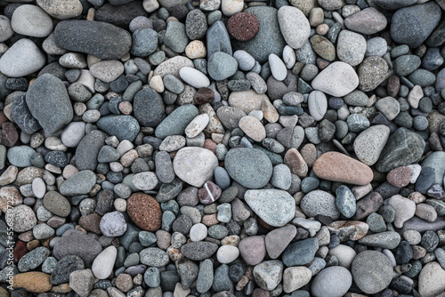 Many different pebbles as background, top view
